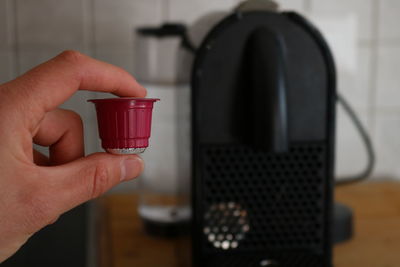 Midsection of person holding coffee cup