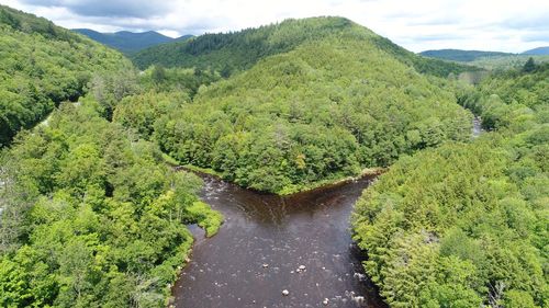 Scenic view of green mountains against sky