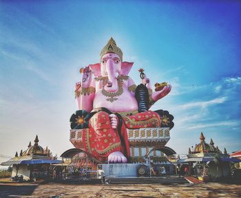 Low angle view of ganesha statue against sky