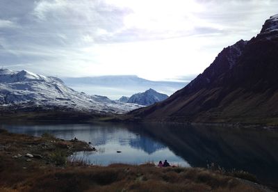 Scenic view of lake and mountains against sky