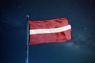 Low angle view of flag against star field at night