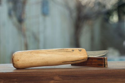 Close-up of knife on wooden table