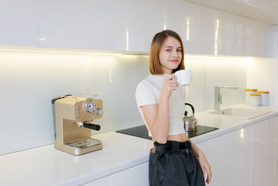 Portrait of young woman standing in bathroom