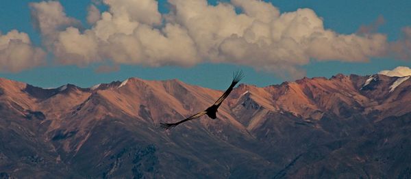 Scenic view of mountains against cloudy sky