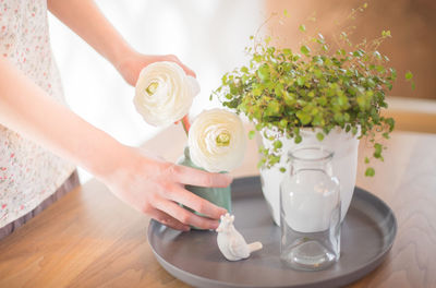 Woman arranging flowers at home
