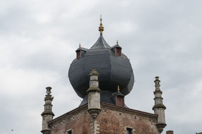 Low angle view of bell tower against sky