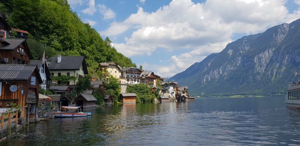 Panoramic shot of townscape by lake against sky