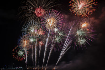 Low angle view of firework display at night
