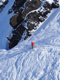 High angle view of person skiing downhill on snow