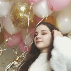 Portrait of young woman with balloons