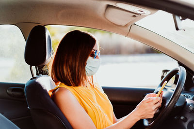 Portrait of woman sitting in car