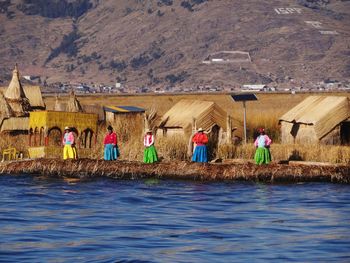 Group of people on landscape against mountain range