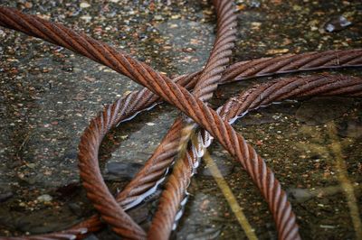 Close-up of rusty metallic rope in water