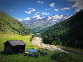 Scenic view of field and mountains against sky