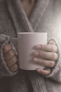 Close-up of hand holding coffee cup