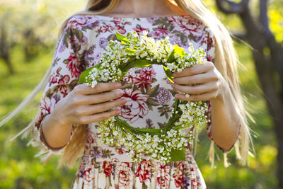 Close-up of woman holding flowering plants