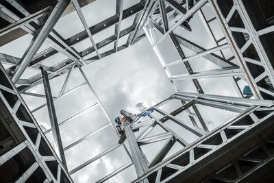 Low angle view of man working at construction site