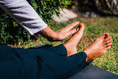 Hands of a reiki therapist healing and balancing energy points in feet. energy healing concept