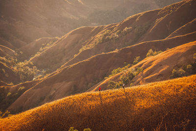 People walking on landscape and mountains