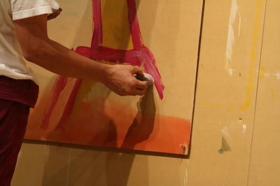 Close-up of young woman standing against wall