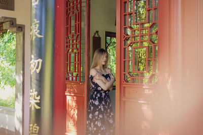 Woman standing on doorway