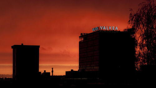 Low angle view of skyscraper against sky at dusk