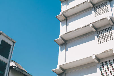 Low angle view of buildings against clear blue sky