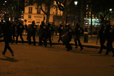 People walking on street in city at night