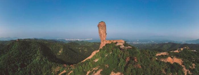 Rock formations on landscape against blue sky