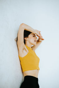 Young woman standing by white background