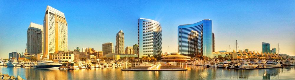 Panoramic view of skyscrapers against blue sky