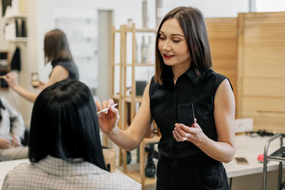 The makeup artist works in her salon, applies professional makeup. beauty industry, make-up