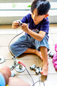 Boy playing on tiled floor