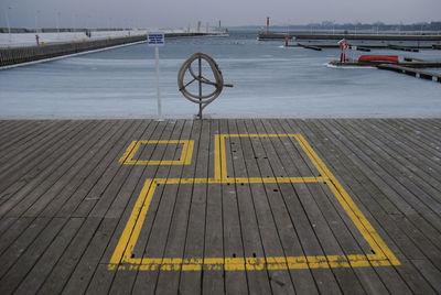 Pier on harbor against sky