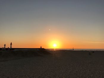 Scenic view of beach against sky during sunset