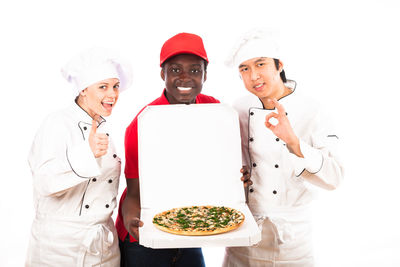 Portrait of friends standing against white background