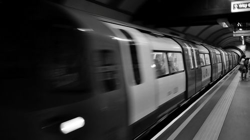 Blurred motion of train at railroad station