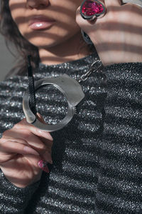 Midsection of woman holding rope