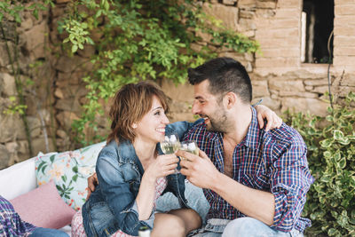 Young couple sitting in a drinking glass