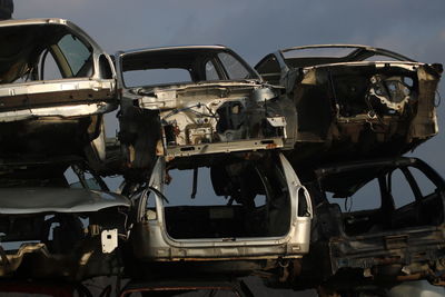 Abandoned car against sky