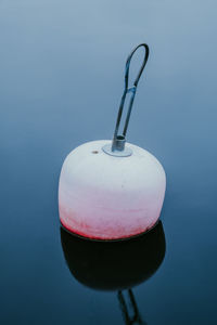 Close-up of drink over water against blue background