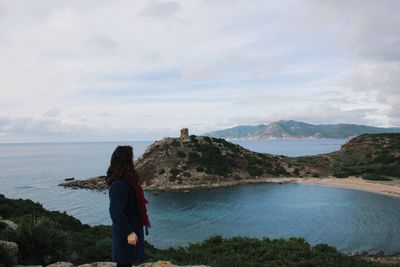 Rear view of woman looking at sea against sky