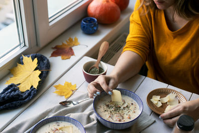 High angle view of woman having food at home