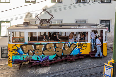 People sitting on railroad track in city