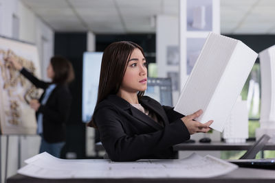 Portrait of woman using laptop at office