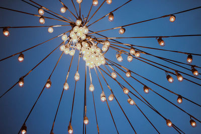 Low angle view of illuminated chandelier against sky