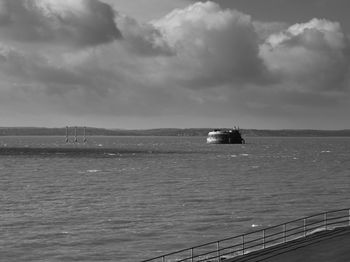 Boat sailing in sea against sky