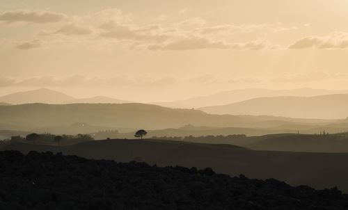 Scenic view of silhouette mountains against sky during sunset