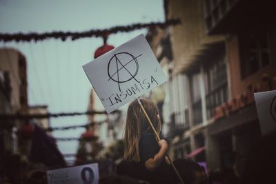 Close-up of man holding paper with text