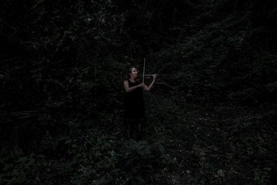 Rear view of a woman standing on grass
